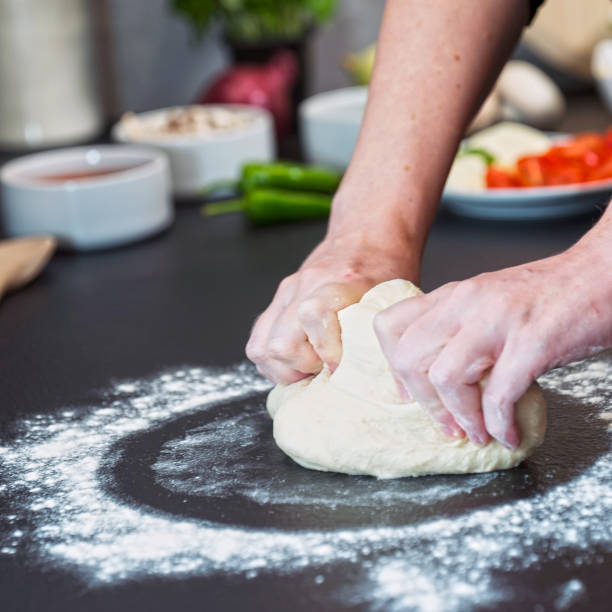 istock making homemade Italian-style pizza 1179589526