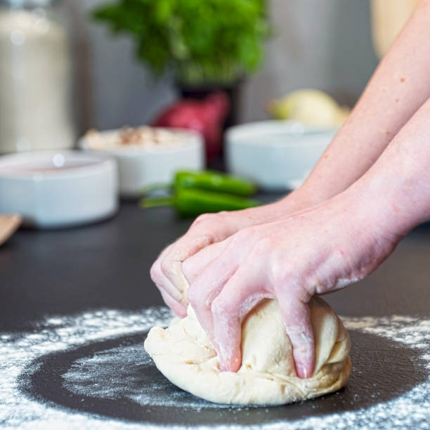 istock making homemade Italian-style pizza 1179589546