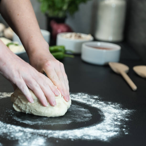 istock making homemade Italian-style pizza 1179589598