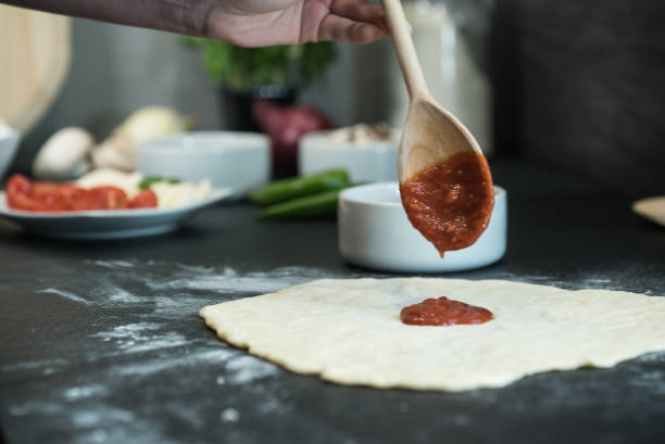 istock making homemade Italian-style pizza 1179591137