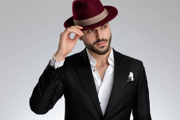 istock businessman fixing his hat and looking away pensive 1179592153