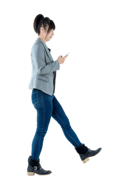 istock Busy businesswoman walking and using phone 1179592387