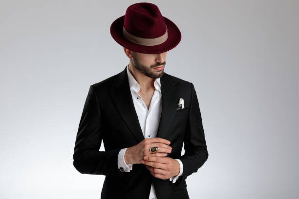 istock mysterious businessman looking sideways with eyes hidden under hat 1179592498