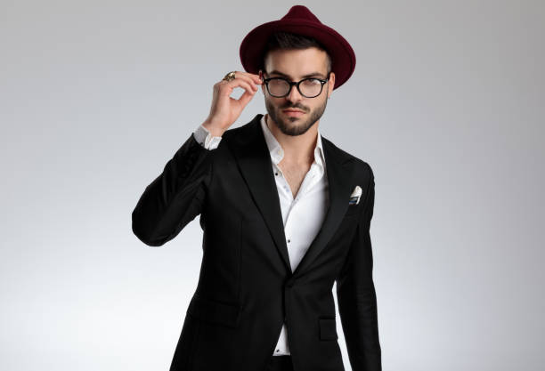 istock businessman fixing glasses and looking at camera seductive 1179592682