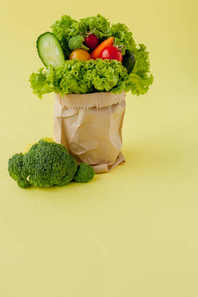 istock Shopping bag with groceries on yellow background 1179592955