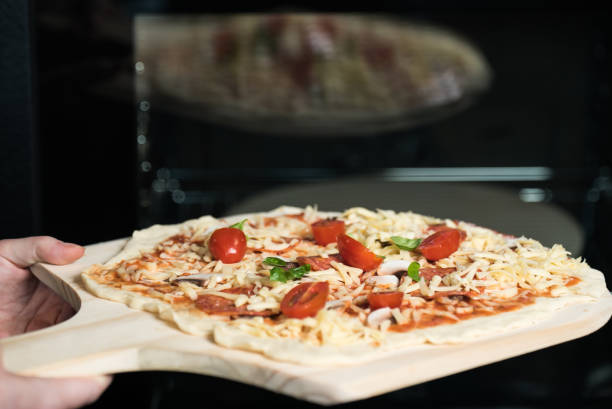 istock making homemade Italian-style pizza 1179594442