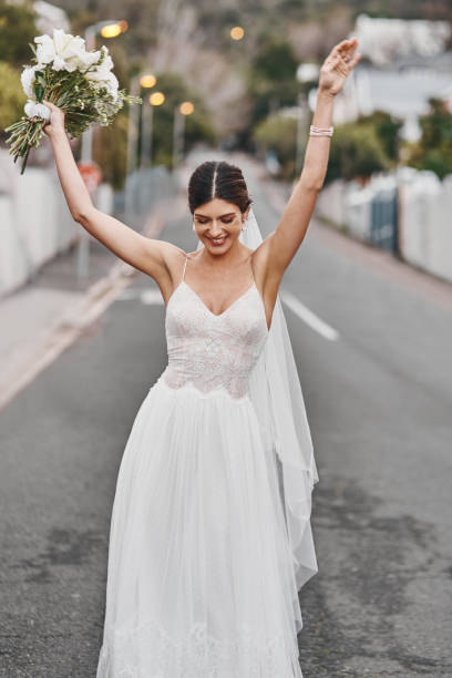 I married the man of my dreams Cropped shot of a beautiful bride standing outside wedding dresses stock pictures, royalty-free photos & images