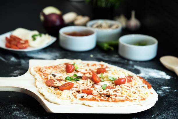 istock making homemade Italian-style pizza 1179595582