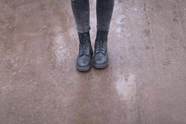 istock Female legs in black boots close-up 1179595630