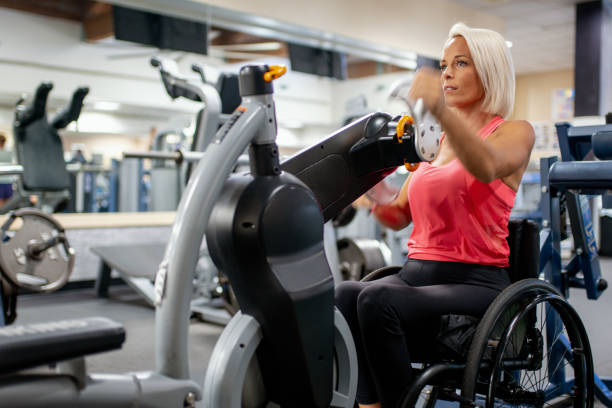 istock Adaptive athlete in a wheelchair using a seated cycling machine 1179595723