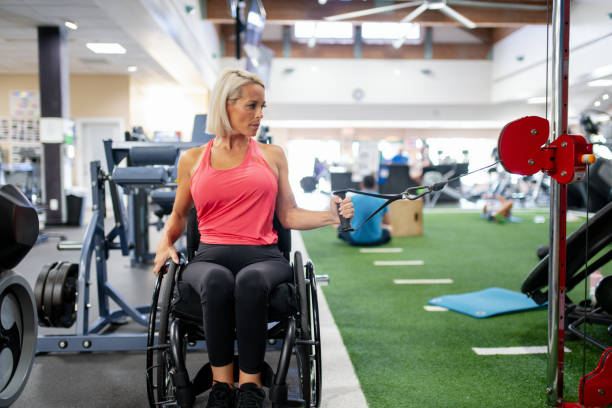 istock Adaptive athlete in a wheelchair working out in a gym 1179595765