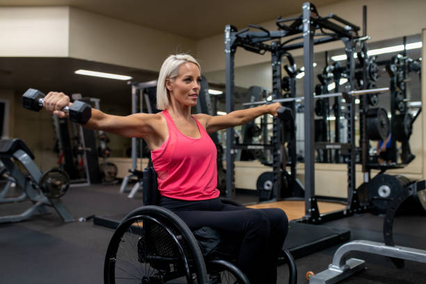 istock Adaptive athlete in a wheelchair lifting weights 1179595774