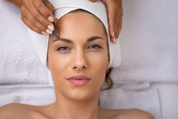 Beautiful young woman gets eyebrow correction procedure