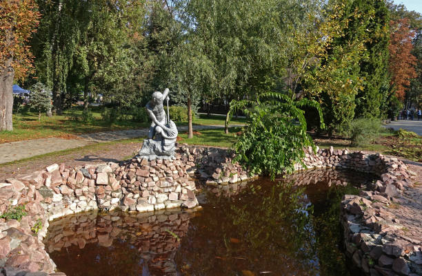 TKiev. Ukraine. October 01, 2019 he ancient Black Sea fountain in Shevchenko park in autumn in Kiev. Sculpture of a boy fisherman who caught a fish above the water