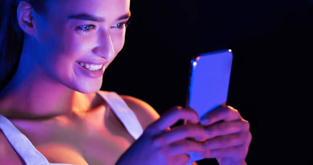 istock Millennial woman texting on cellphone in dark room 1179597212