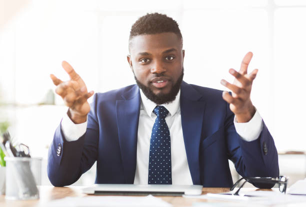 Handsome angry businessman looking at camera, talking and gesturing