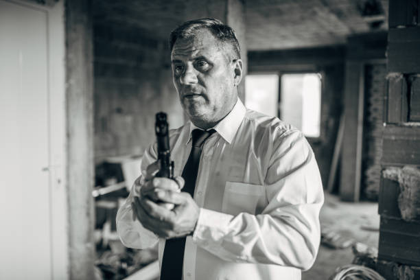 An older man with a gun in action