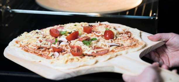 istock making homemade Italian-style pizza 1179597851