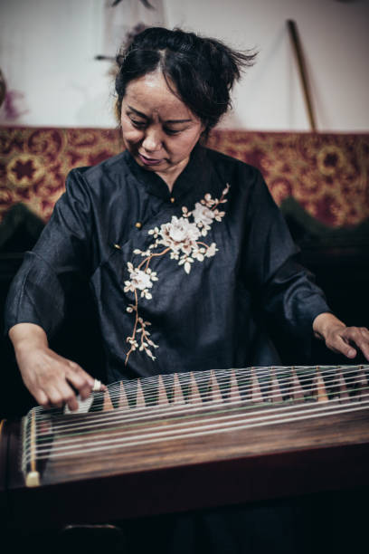 istock Chinese woman playing traditional harp 1179597916