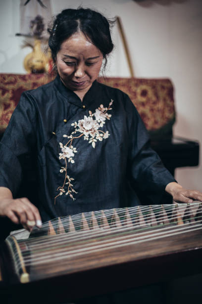 istock Chinese woman playing traditional harp 1179597968