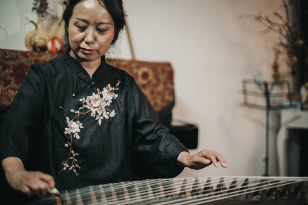 istock Chinese woman playing traditional harp 1179597983