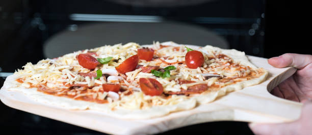 istock making homemade Italian-style pizza 1179598595