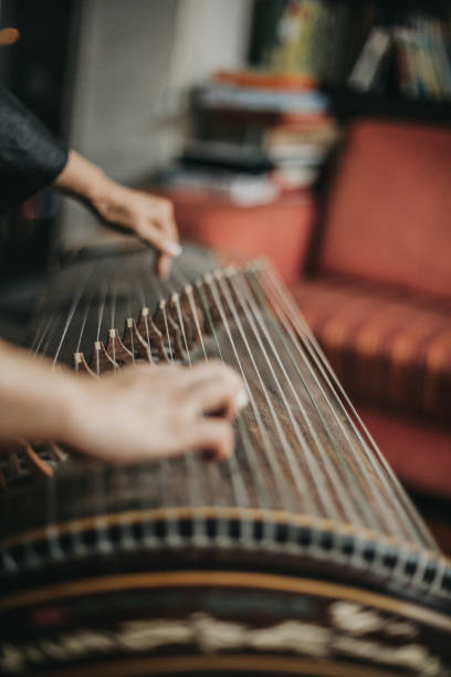 istock Woman playing the harp 1179599116