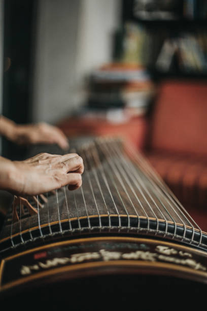 istock Woman playing the harp 1179599128