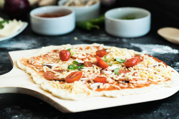 istock making homemade Italian-style pizza 1179599163