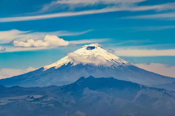 Stock photograph of the snowy peek of the Cotopaxi stratovolcano in the Andes Mountains in Ecuador, South America.