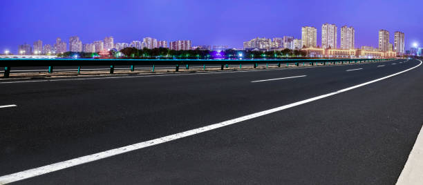 istock Highway and modern city night scene background 1179599380