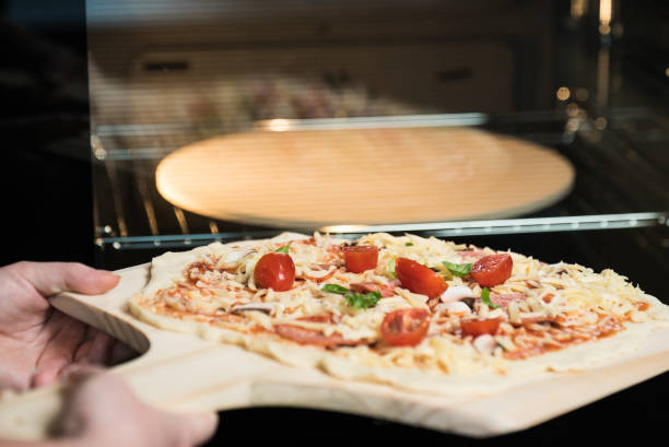 istock making homemade Italian-style pizza 1179599390