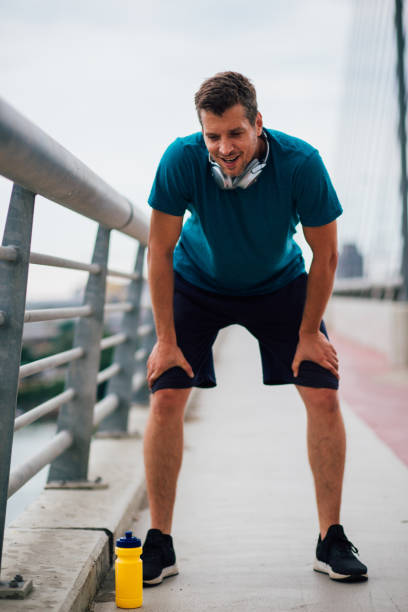 istock Young man cooling down after a running session on the bridge 1179599427