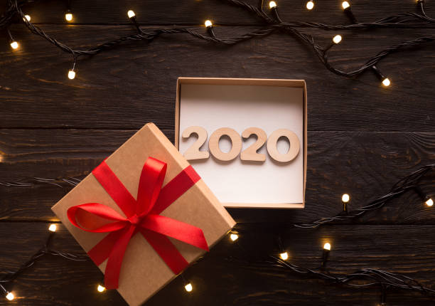 istock 2020 New year concept in open gift box on wooden background 1179599613