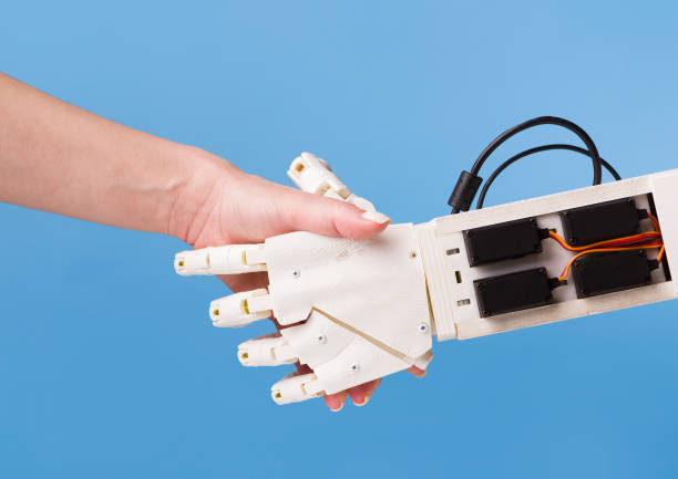 istock Robot and human handshake. Cooperation of people and technology. 1179600323
