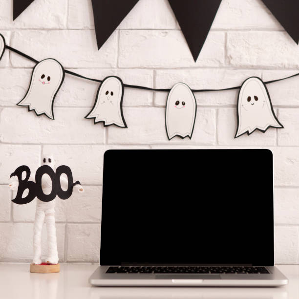 Modern laptop with black blank screen on white table