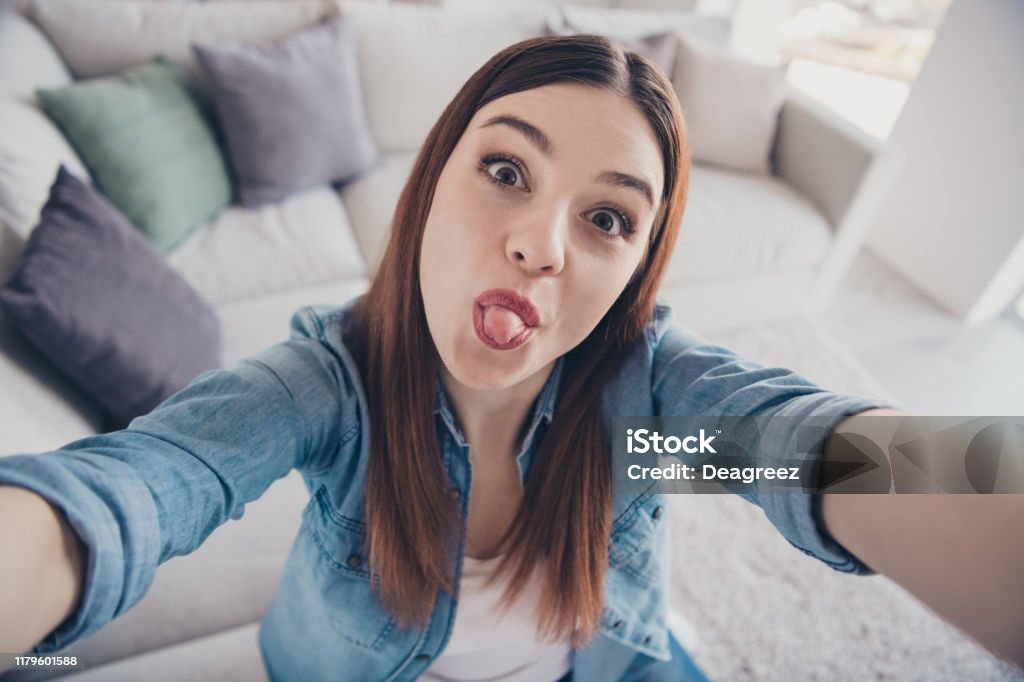 Close Up Photo Of Funny Funky Crazy Girl Have Video Call With Her Best Friends Show Tongue Take Selfie Enjoy Summer Spring Vacation Wear Denim Jeans Clothes Indoors Stock Photo - Download Close Up Photo Of Funny Funky Crazy Girl Have Video Call With Her Best Friends Show Tongue Take Selfie Enjoy Summer Spring Vacation Wear Denim Jeans Clothes Indoors Stock Photo - Download