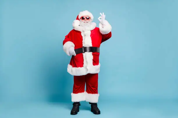 Full length body size view of his he nice content cool cheerful cheery fat bearded Santa wearing, warm winter coat look outfit showing ok-sign isolated over blue turquoise pastel color background
