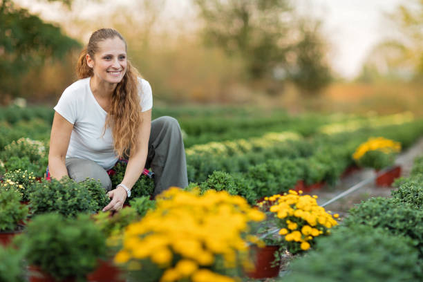 istock Woman gardening flowers 1179602688