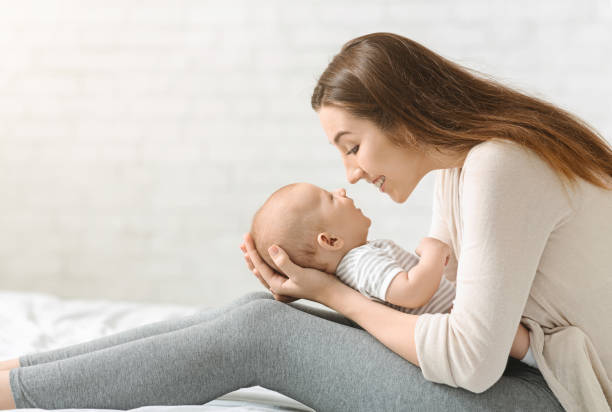 istock Happy young woman enjoy spending time with her infant son 1179602722