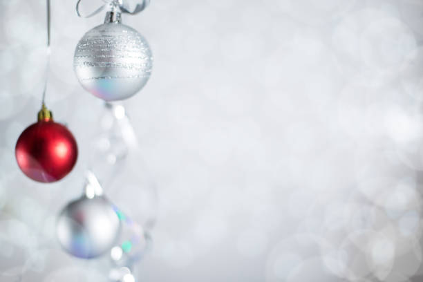 Fake silver christmas tree with red ornament