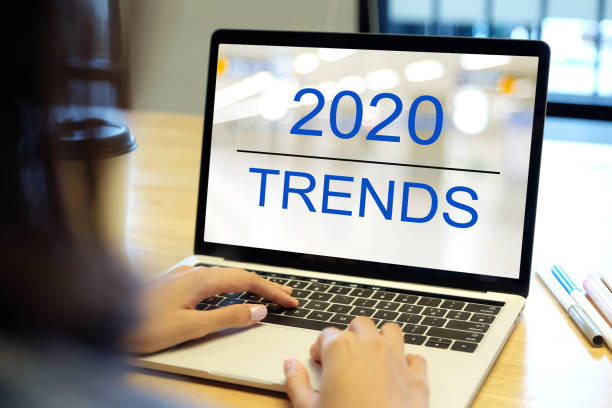 istock 2020 digital trends, Woman hand tying laptop computer with 2020 trends on screen background, digital marketing, business and technology concept 1179604414