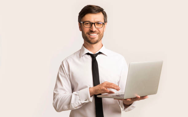 istock Successsful Man Working On Laptop Standing Over White Background 1179604437