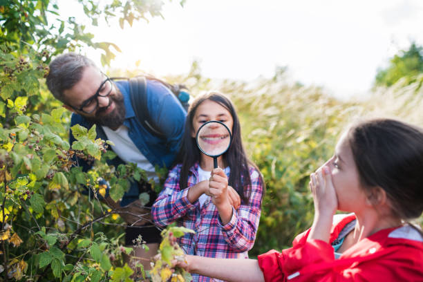 istock School children with teacher on field trip in nature, learning science. 1179604478