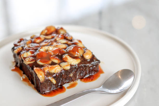 istock Toffee cake on a white plate with a spoon. 1179604658