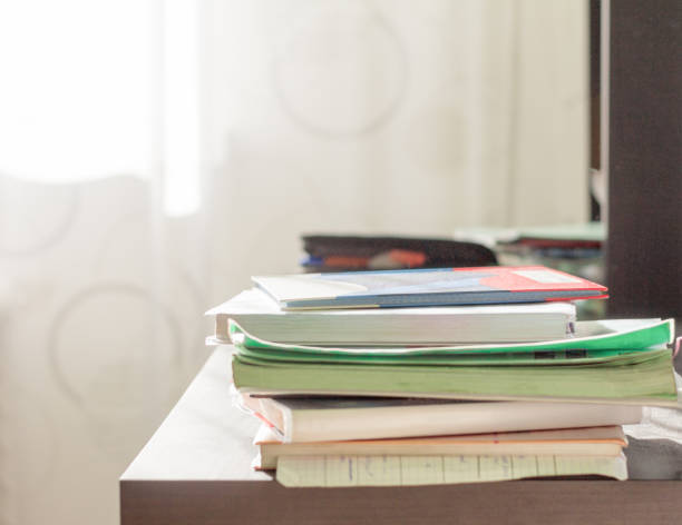 istock notebooks and textbooks in a mess on the student's Desk 1179604787