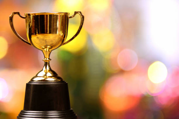 istock Gold trophy cup on full color background with bokeh 1179605582