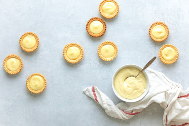 Tartlets filled with plain homemade custard Tartlets filled with plain homemade custard, top down view custard stock pictures, royalty-free photos & images