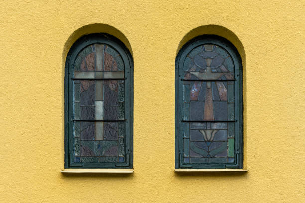 istock Vibrant yellow stone wall with mosaic vaulted windows 1179606112