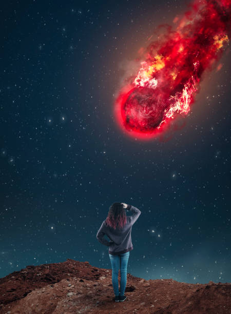 istock Confused woman looking up to a falling meteorite during night. 1179607459